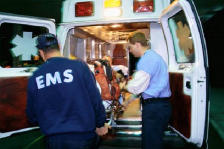 EMS Personnel loading patient into an ambulance
